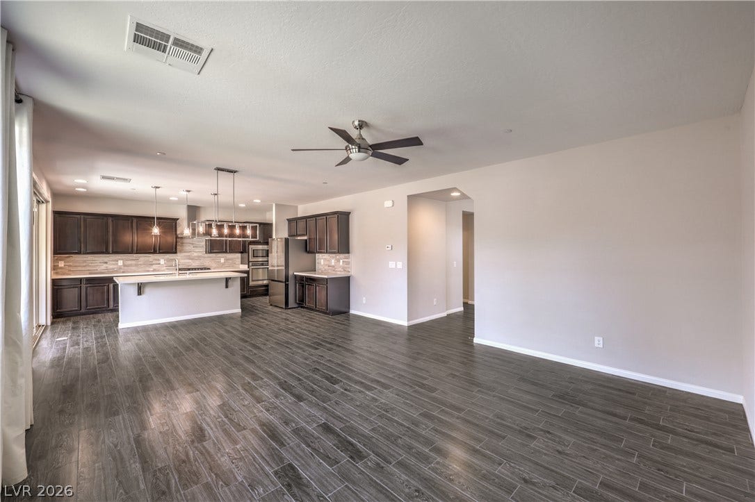 413 Via Gigante, Henderson, NV 89011 An open-concept layout unites kitchen and living spaces under high ceilings, perfect for entertaining.