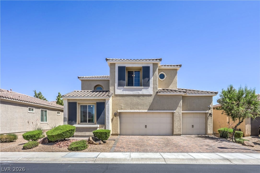 413 Via Gigante, Henderson, NV 89011 Mediterranean-inspired facade with decorative shutters and an attached three-car garage provides exceptional curb appeal.