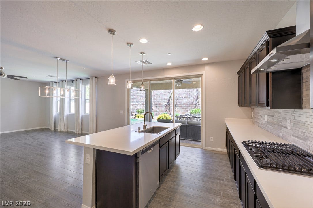 413 Via Gigante, Henderson, NV 89011 The kitchen offers an island with ample counter space and overlooks the bright living area.