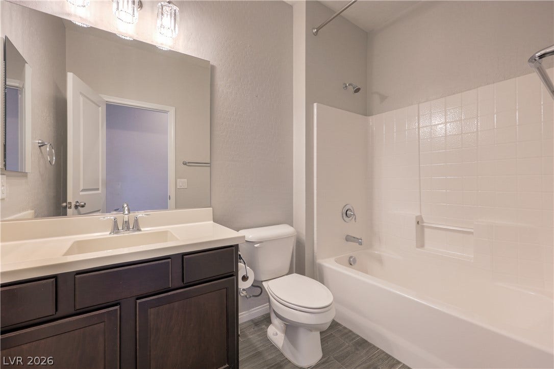 413 Via Gigante, Henderson, NV 89011 A well-appointed bathroom with a spacious vanity, sleek fixtures, and clean tile flooring.