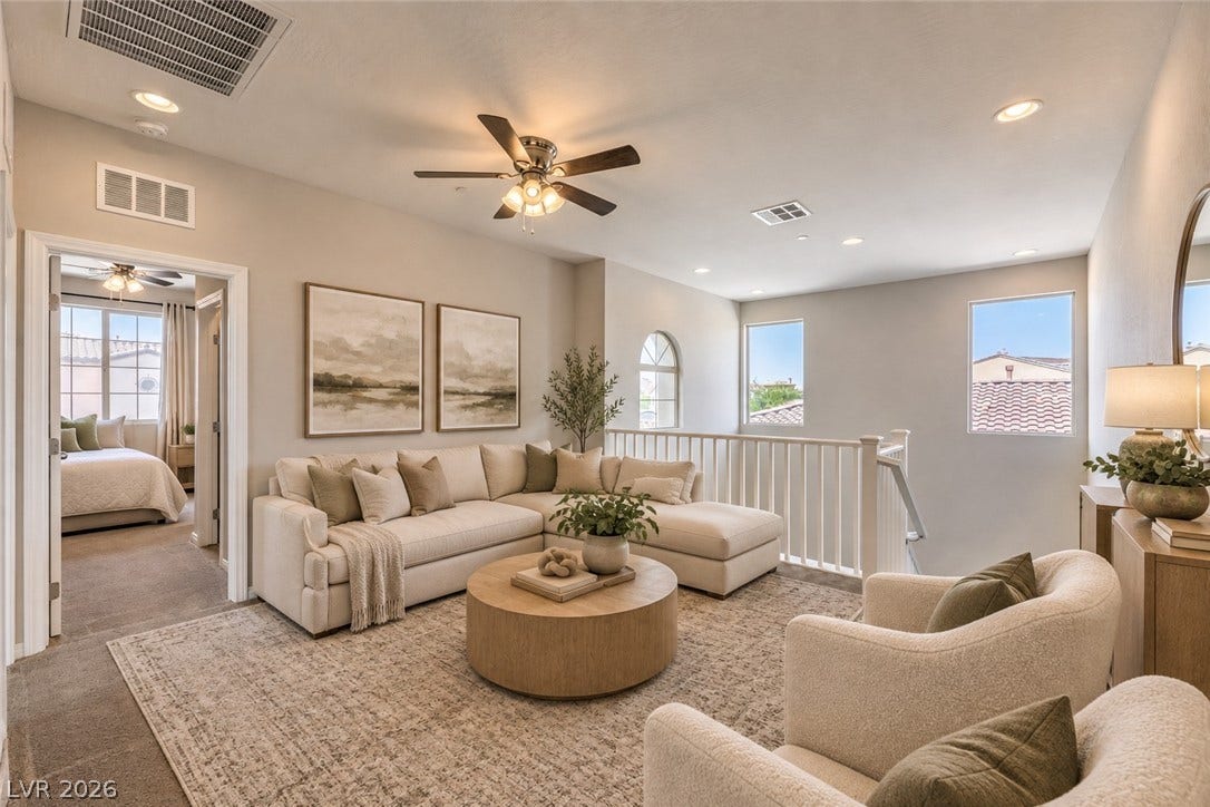 413 Via Gigante, Henderson, NV 89011 An open loft space upstairs features neutral carpeting, recessed lighting, and white wooden stair railings.