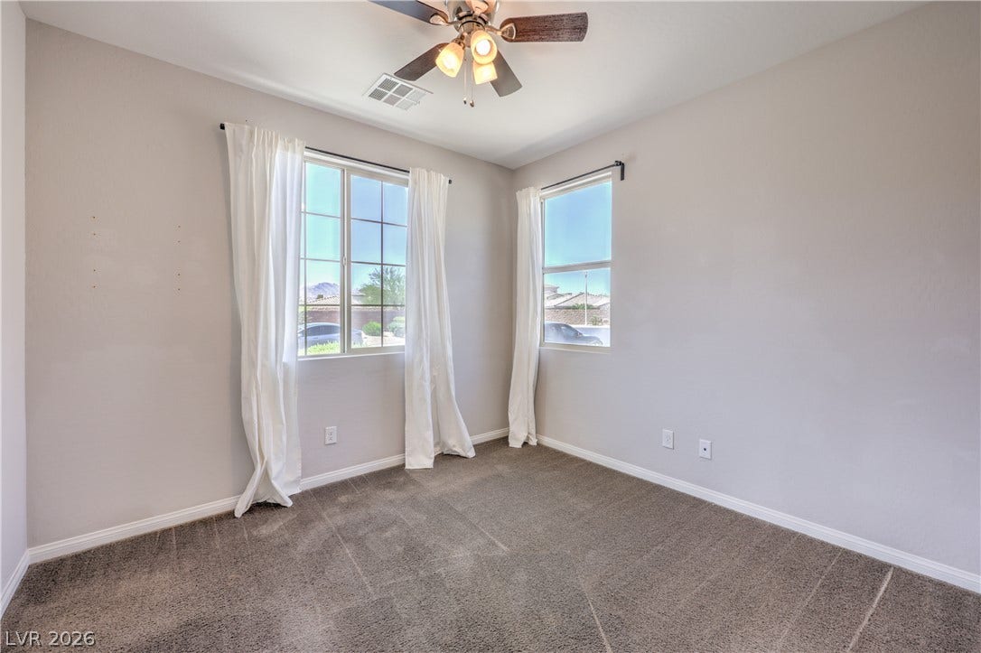 413 Via Gigante, Henderson, NV 89011 Well-lit room featuring multiple windows and a practical ceiling fan.