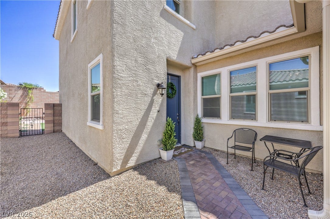 413 Via Gigante, Henderson, NV 89011 A welcoming brick paver pathway leads to the main entrance of this inviting home.