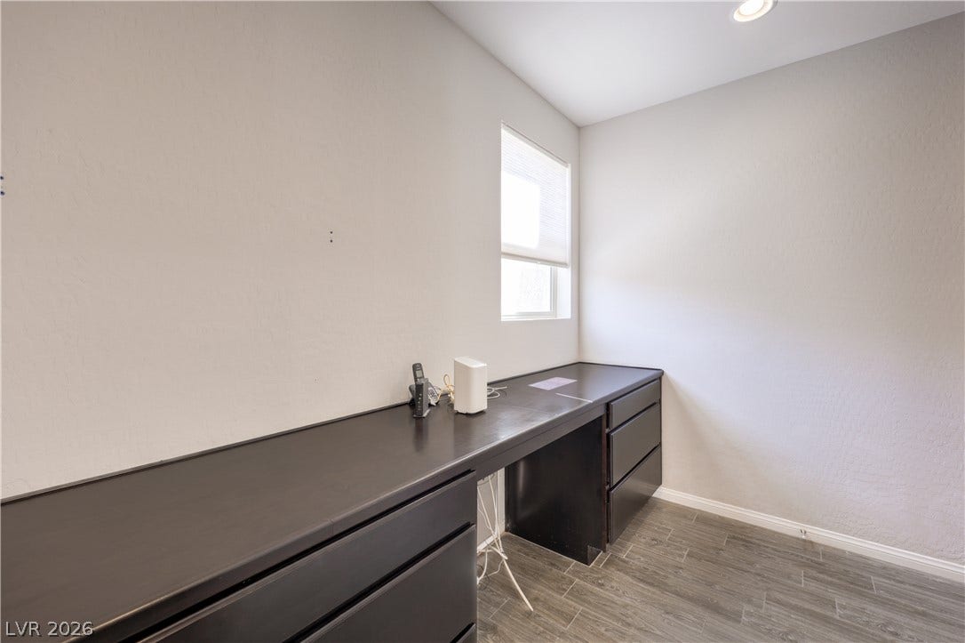 413 Via Gigante, Henderson, NV 89011 A well-lit room offers a dedicated workspace with built-in cabinetry and durable flooring.