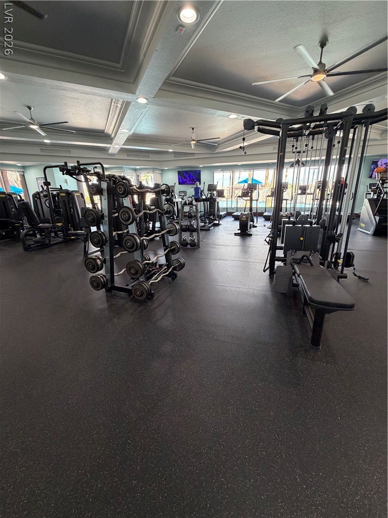 413 Via Gigante, Henderson, NV 89011 A spacious fitness facility features textured durable flooring under deeply coffered ceilings.