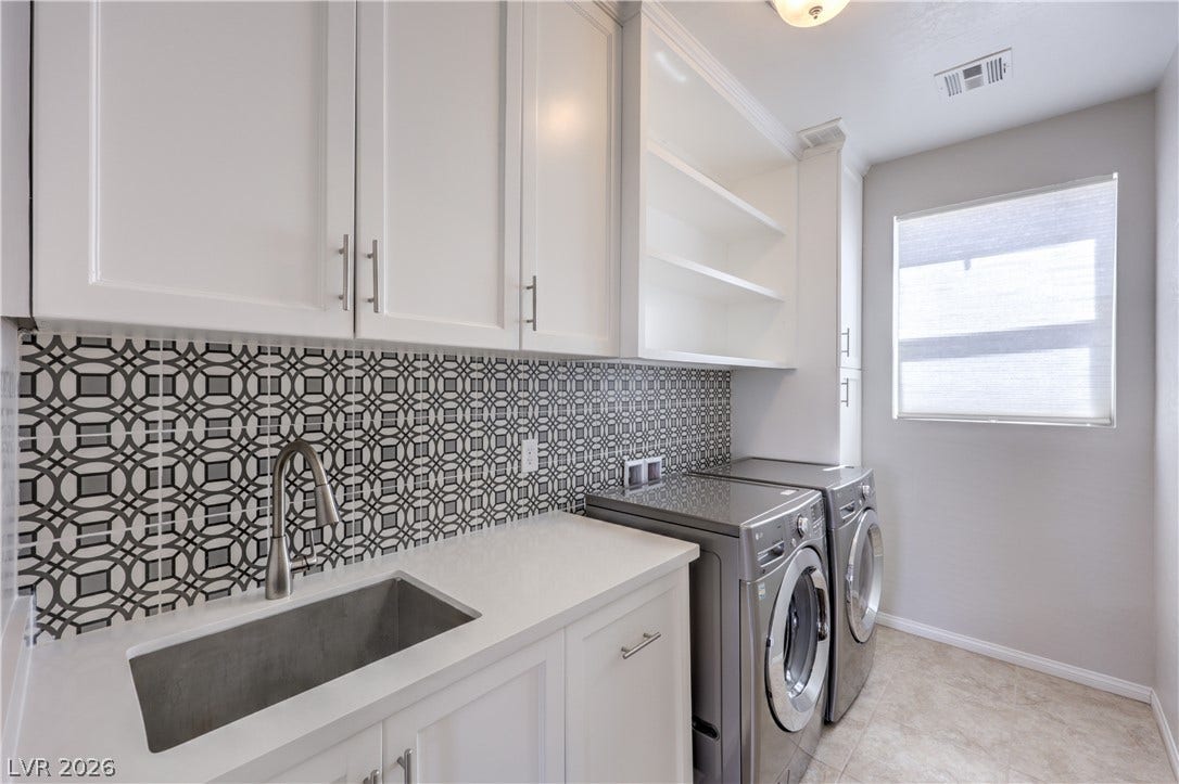 413 Via Gigante, Henderson, NV 89011 Functional utility room with ample storage and contemporary appliances to streamline household tasks.