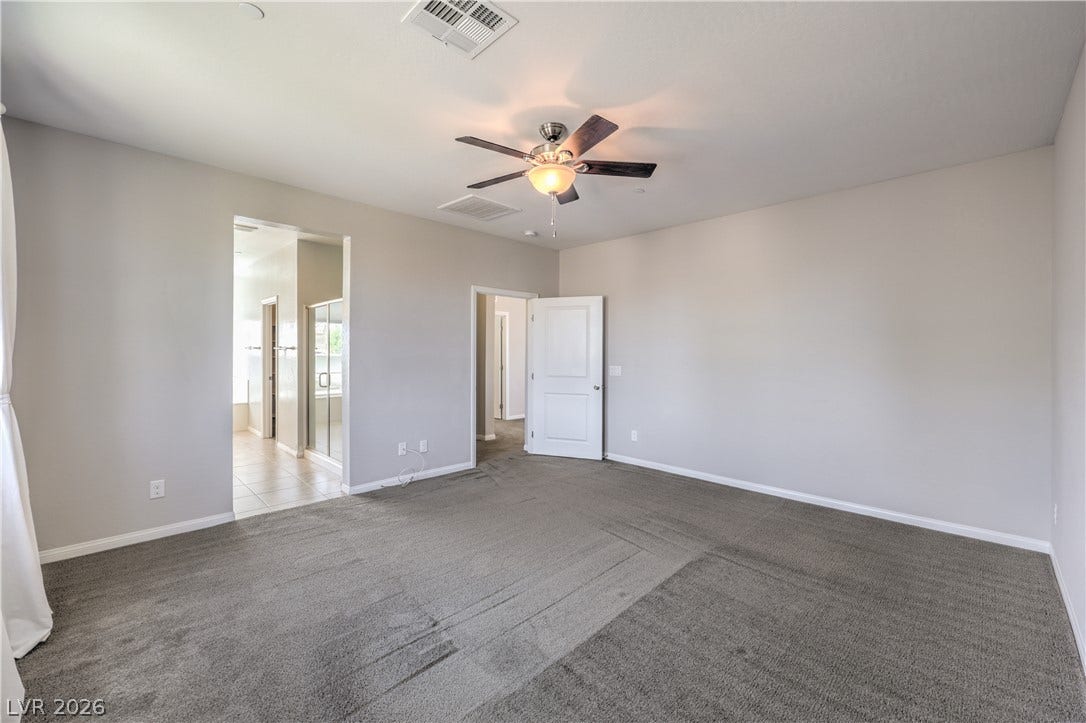 413 Via Gigante, Henderson, NV 89011 A quiet retreat with a ceiling fan, plush carpet, and easy access to the private bathroom.