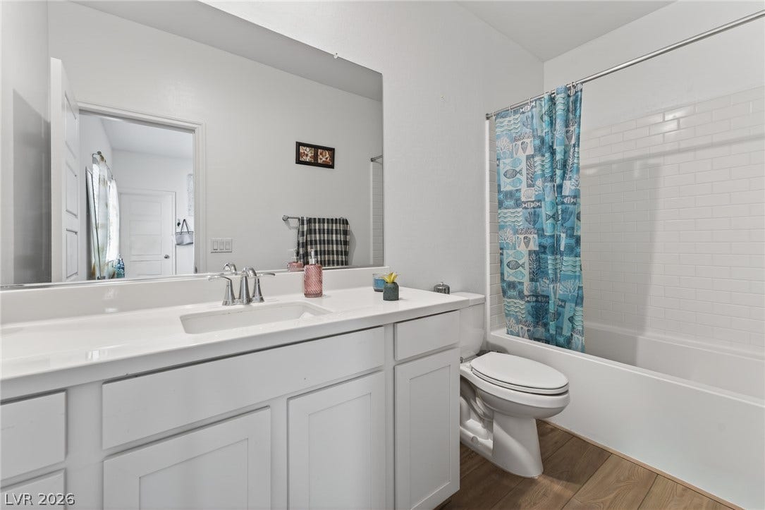 3700 Canis Minor Lane, #19206, Henderson, NV 89052 Crisp white cabinetry pairs with classic subway tile surrounds in this full bathroom.