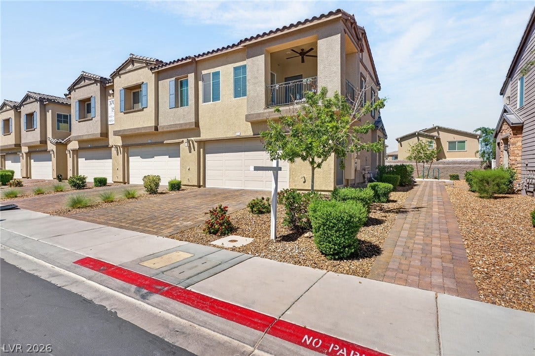 3700 Canis Minor Lane, #19206, Henderson, NV 89052 A paved driveway and walkway complement the classic multi-level architecture and tiled roofline.
