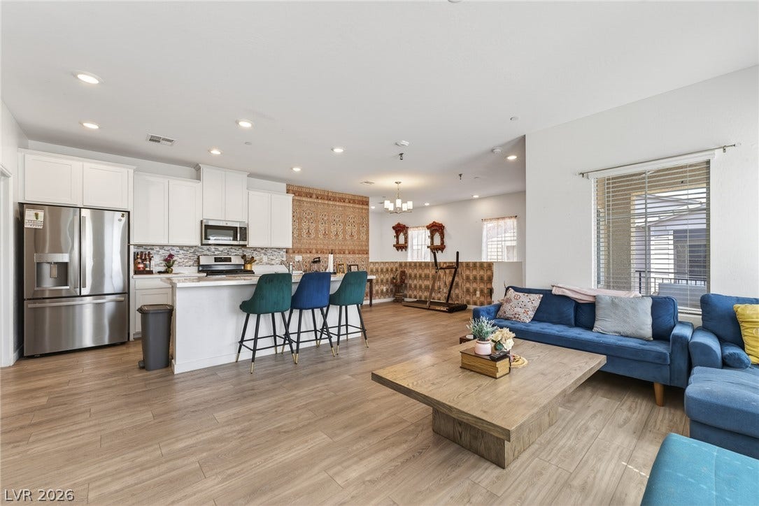 3700 Canis Minor Lane, #19206, Henderson, NV 89052 Warm wood-look flooring and recessed lighting define this versatile open-concept main living area.