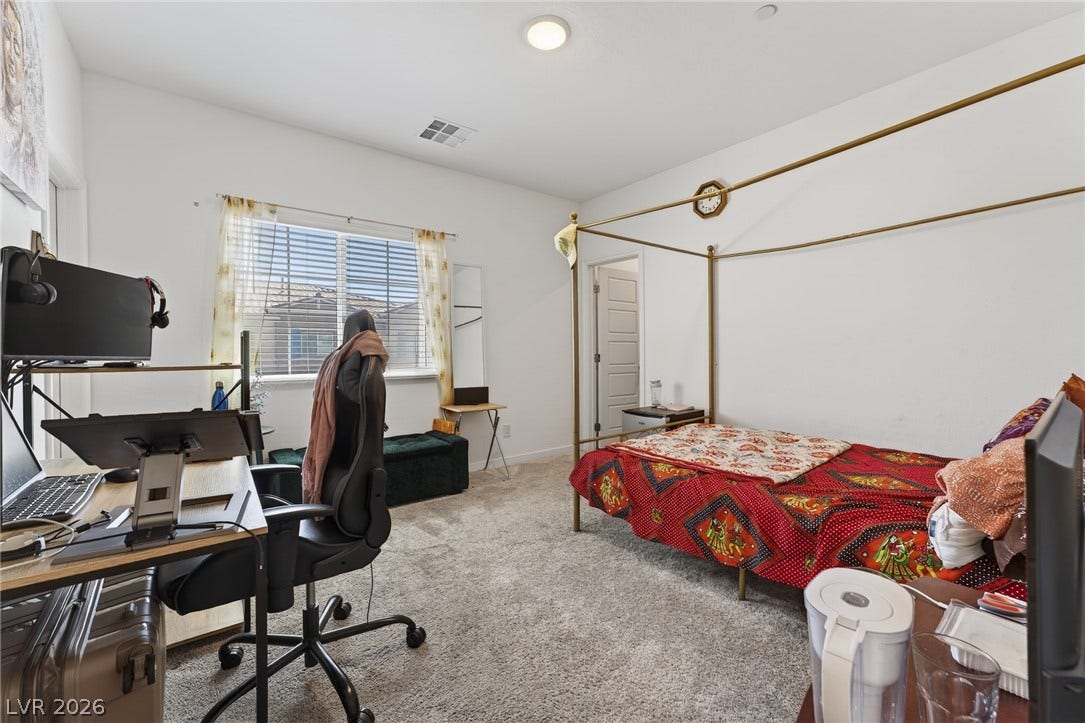 3700 Canis Minor Lane, #19206, Henderson, NV 89052 Plentiful natural light streams across this cozy bedroom through a large street-facing window.