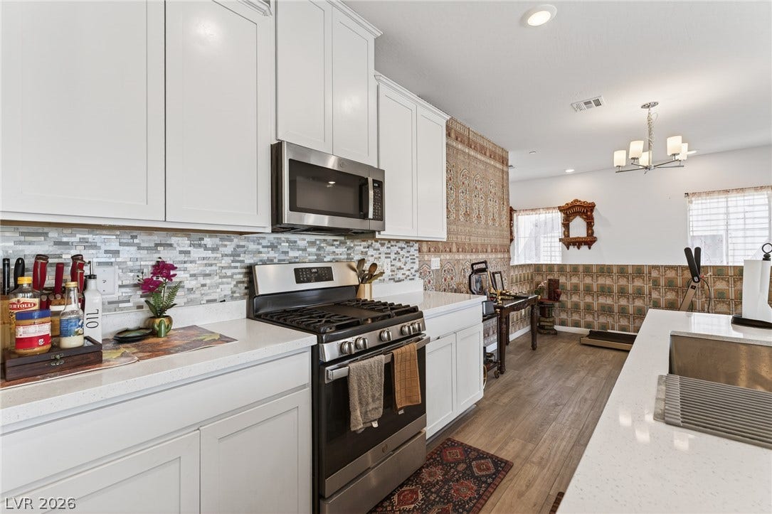 3700 Canis Minor Lane, #19206, Henderson, NV 89052 Modern cabinetry and stone countertops anchor this inviting open-concept kitchen.