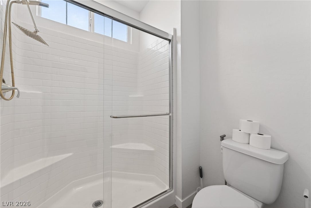 3700 Canis Minor Lane, #19206, Henderson, NV 89052 Clean lines and classic subway tile define this bright bathroom with a glass-enclosed shower.