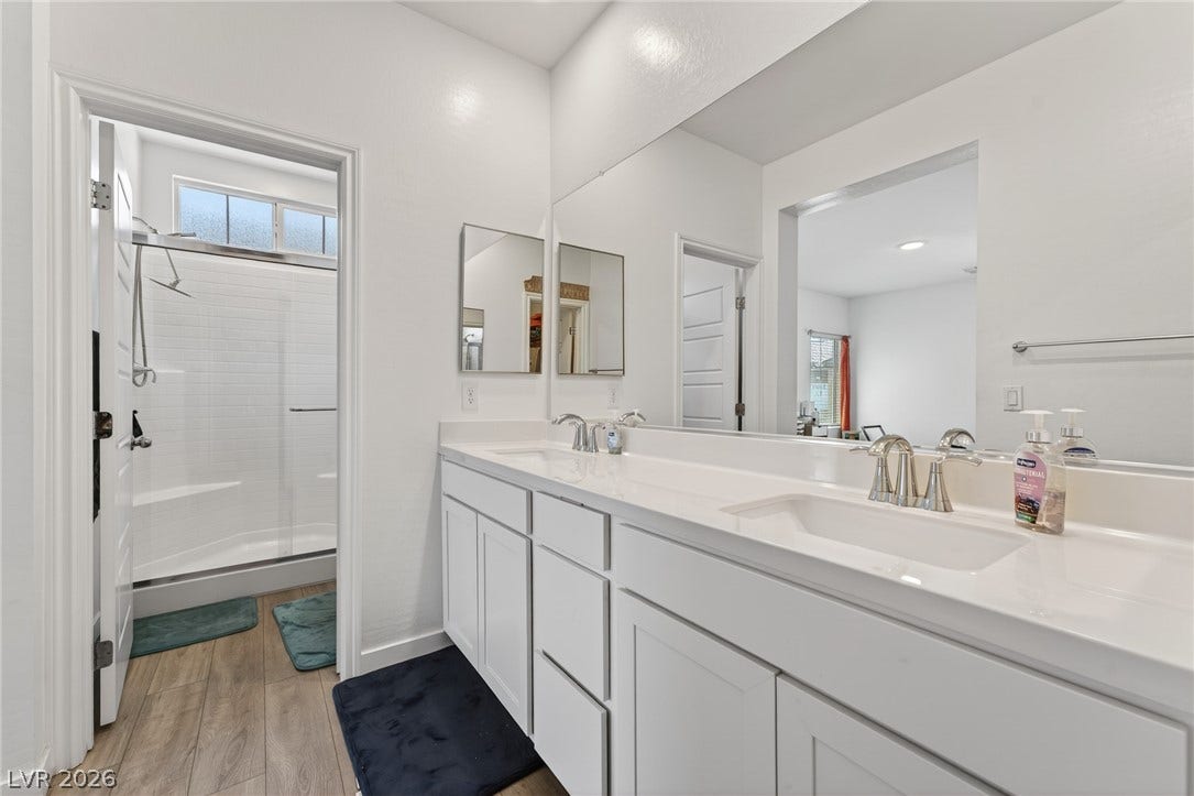 3700 Canis Minor Lane, #19206, Henderson, NV 89052 A spacious double vanity and walk-in shower highlight this modern primary bath design.