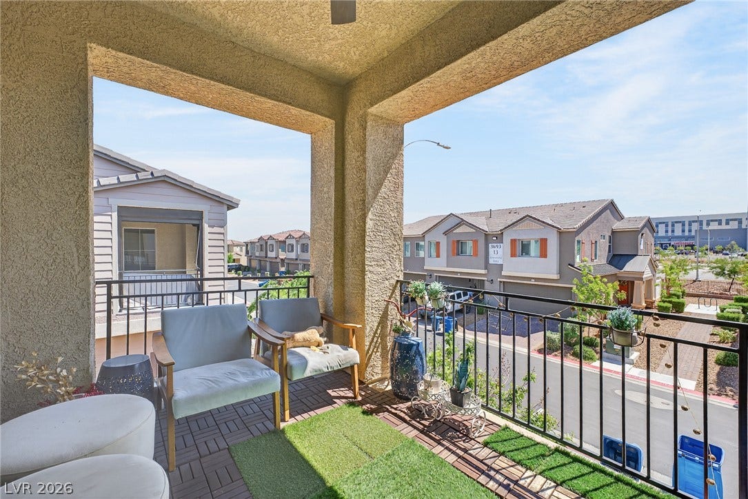 3700 Canis Minor Lane, #19206, Henderson, NV 89052 An elevated private balcony overlooks the neighborhood streets under bright sunny skies.