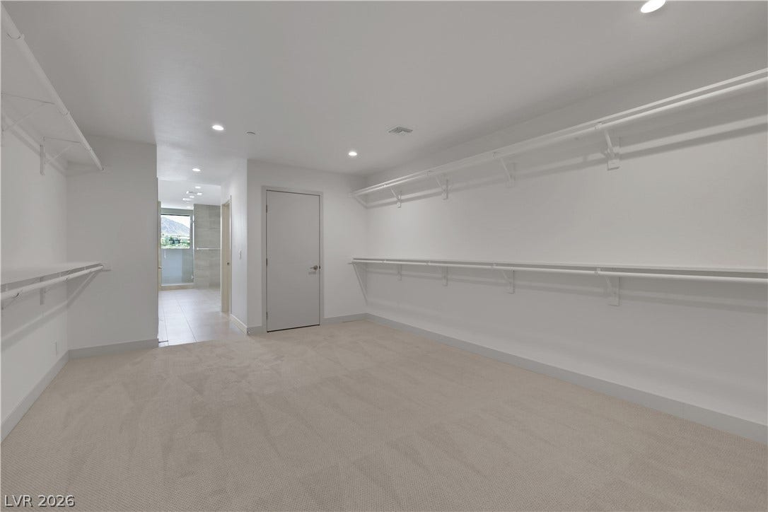 66 Lakefront Drive, Henderson, NV 89011 Ample closet space with built-in shelving offers generous storage solutions, leading to an adjoining bathroom.