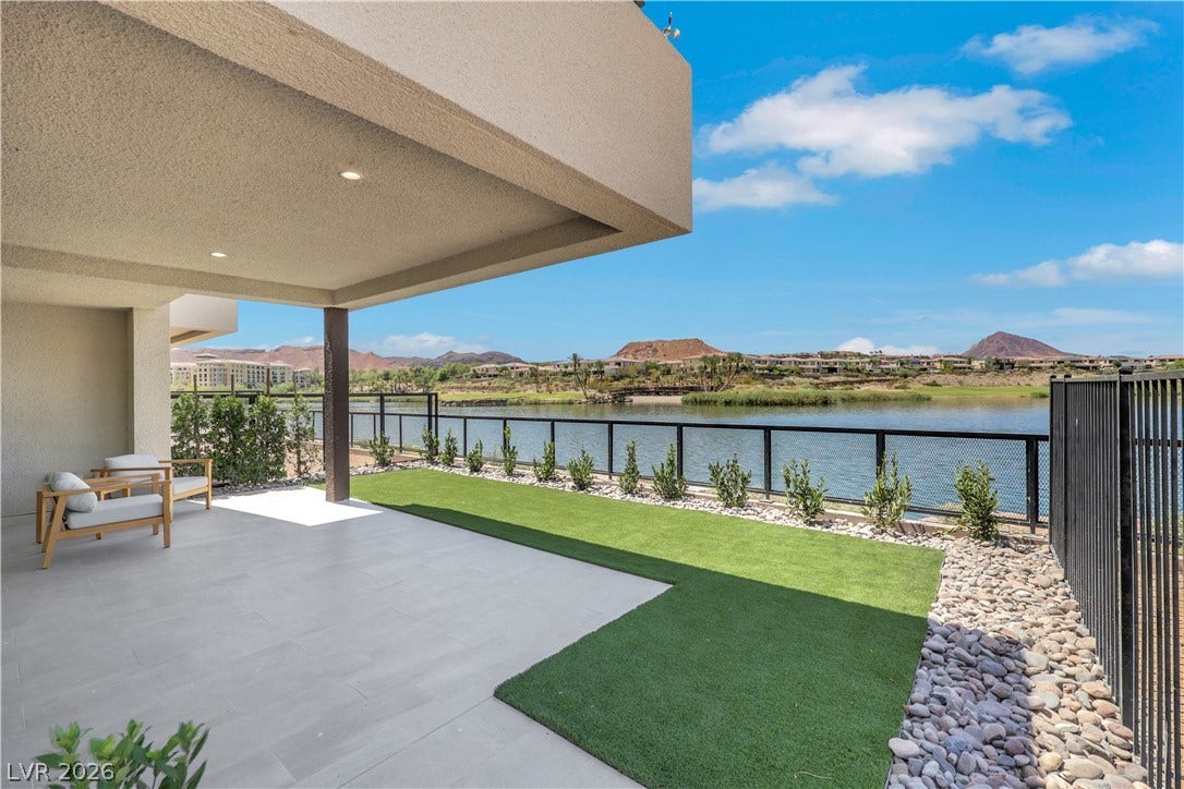 66 Lakefront Drive, Henderson, NV 89011 A spacious covered patio with a lake view, perfect for tranquil outdoor living.