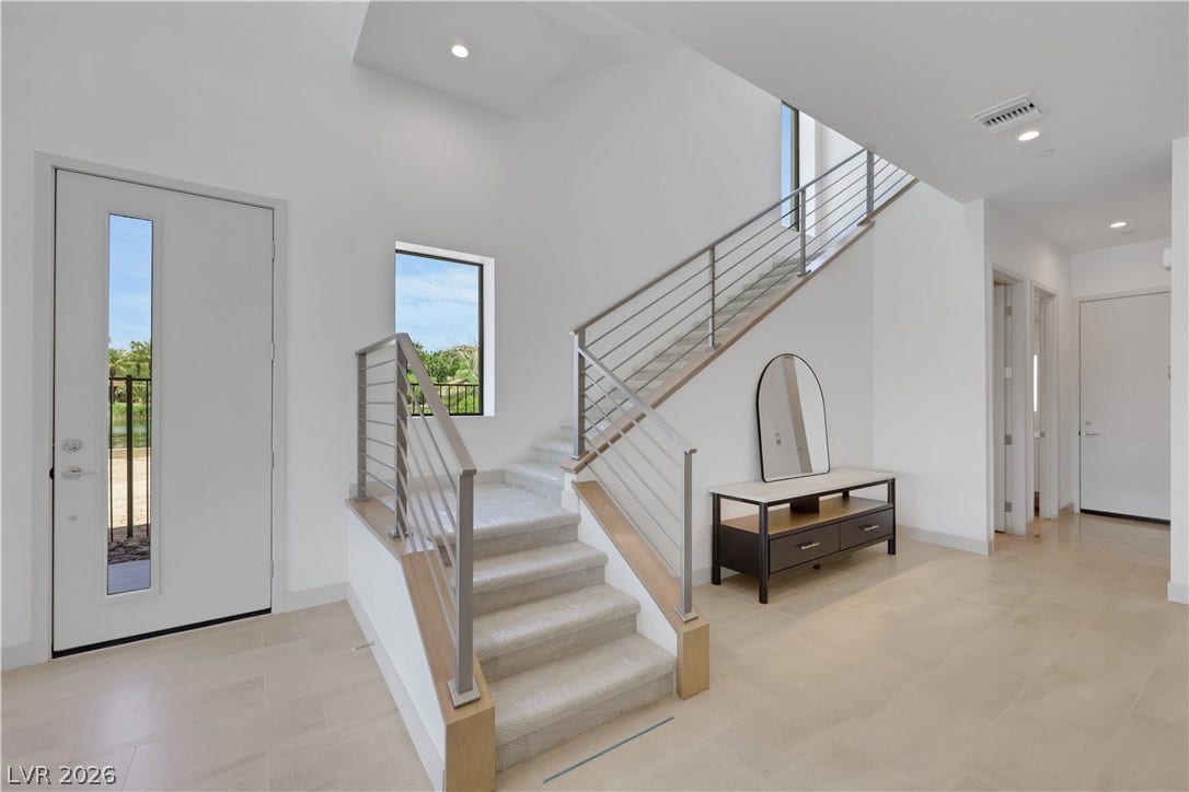 66 Lakefront Drive, Henderson, NV 89011 A grand entry with a contemporary staircase leads to upper levels, illuminated by recessed lighting.