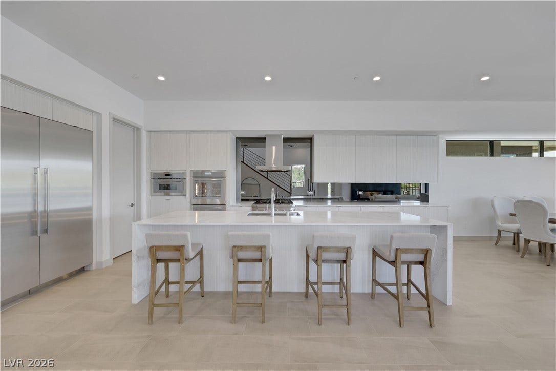 66 Lakefront Drive, Henderson, NV 89011 Culinary excellence awaits in this well-appointed kitchen, featuring a spacious island and state-of-the-art appliances.