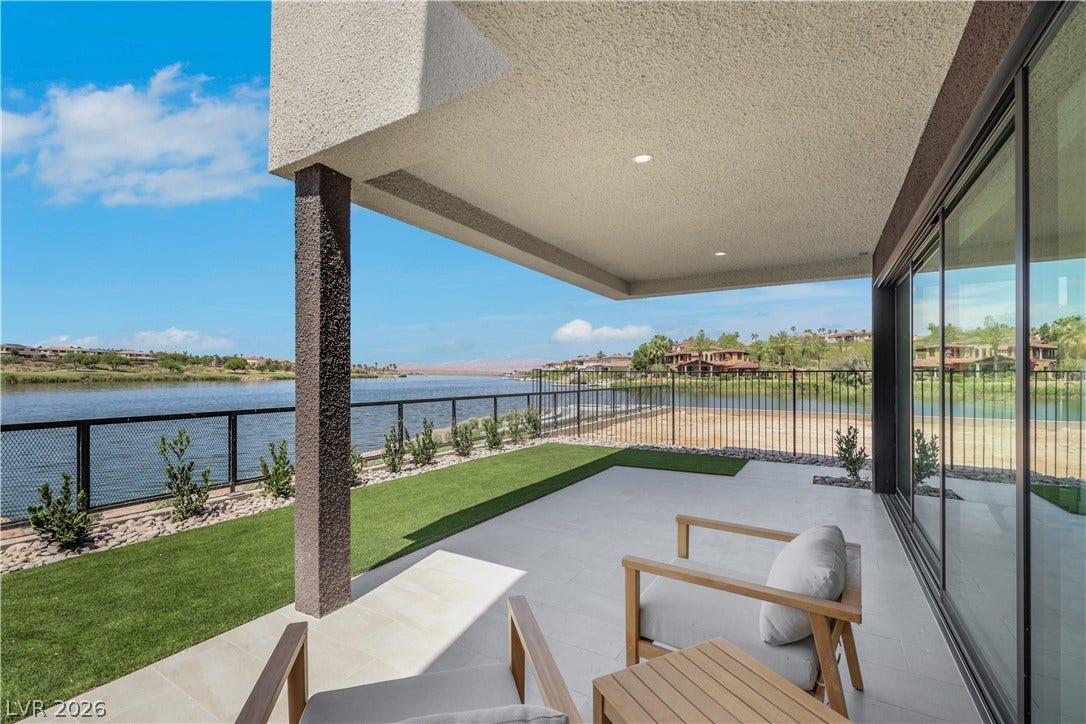 66 Lakefront Drive, Henderson, NV 89011 Enjoy tranquil waterfront views from this serene outdoor covered patio, perfect for relaxation.