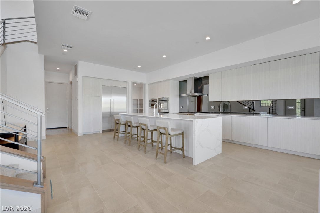 66 Lakefront Drive, Henderson, NV 89011 Culinary excellence awaits in this modern kitchen with stainless appliances and an inviting island.