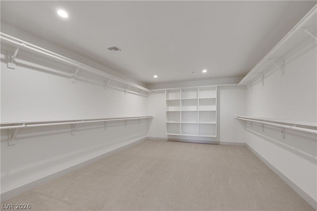 66 Lakefront Drive, Henderson, NV 89011 Ample storage solutions abound within this well-appointed closet, featuring built-in shelving and hanging rods.