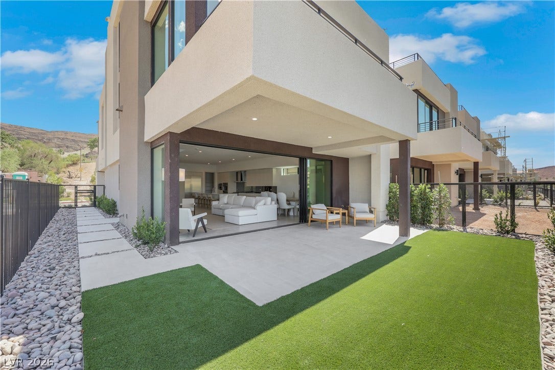 66 Lakefront Drive, Henderson, NV 89011 Seamless indoor-outdoor living awaits with a private patio and lush green space.