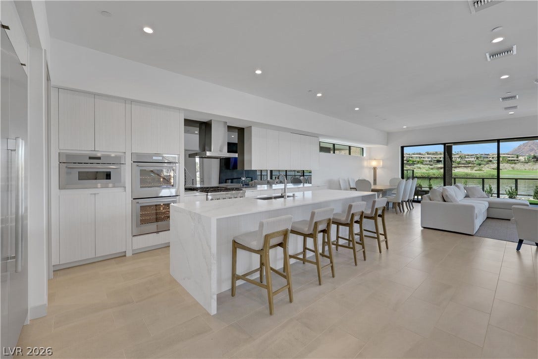 66 Lakefront Drive, Henderson, NV 89011 An open-concept design with a waterfall island and sleek integrated appliances create a luxurious culinary space.