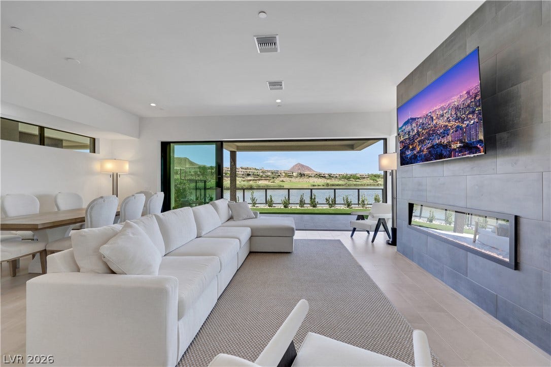 66 Lakefront Drive, Henderson, NV 89011 A spacious living room with serene water views, perfect for luxurious relaxation.