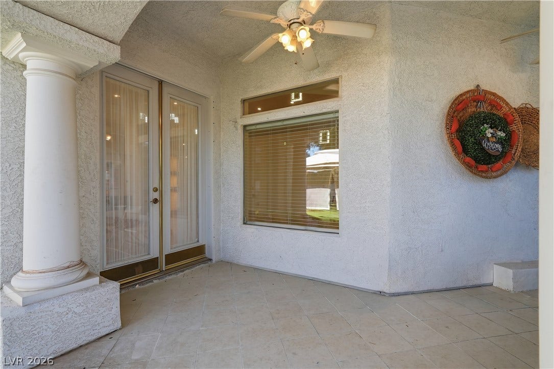 Stucco walls and tiled flooring anchor this sheltered outdoor patio entry.