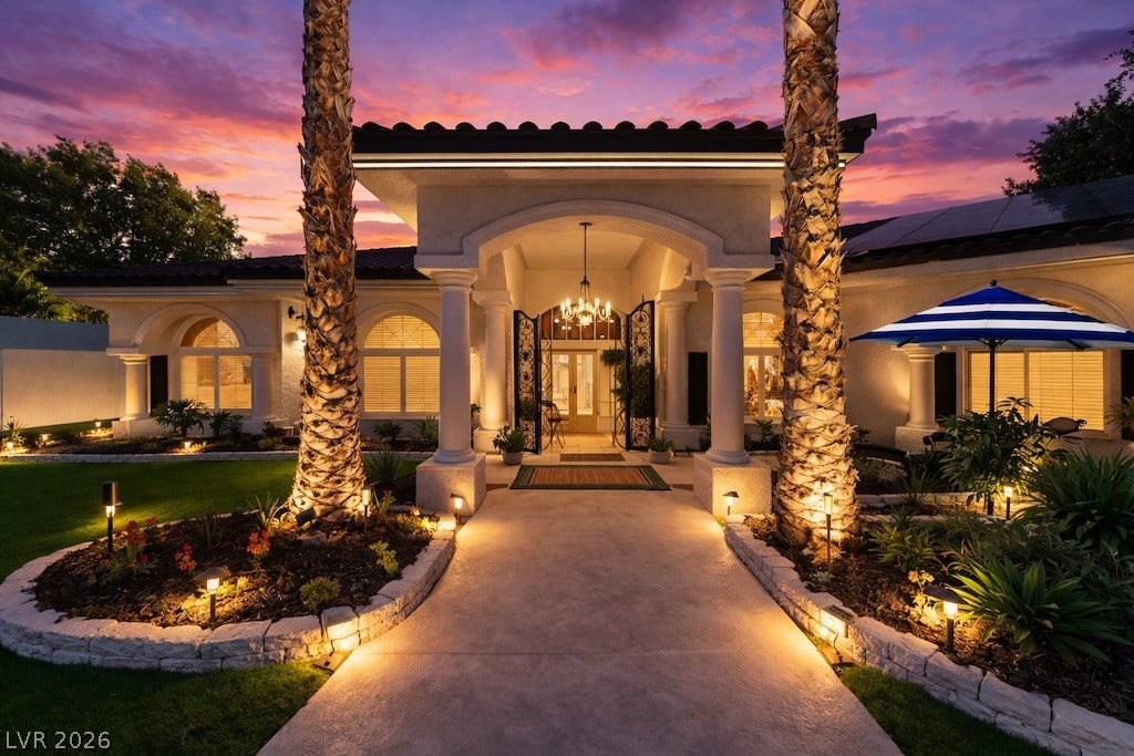 Mediterranean / spanish-style home with stucco siding, solar panels, and a tiled roof