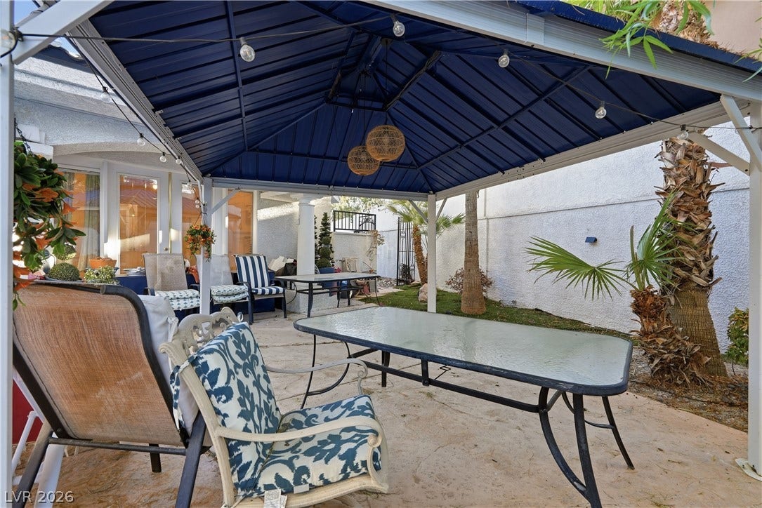 An inviting covered patio offers the perfect space for outdoor relaxation and entertaining.