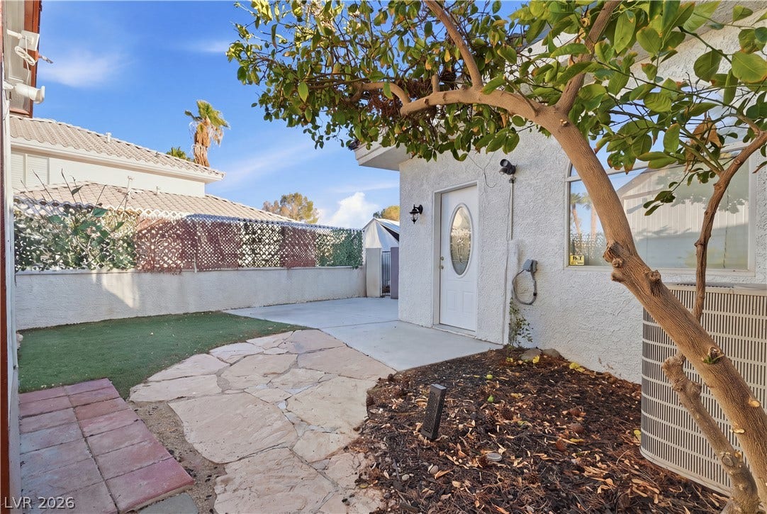 Flagstone paving and a concrete patio define this private outdoor space.