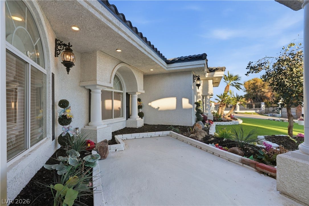 Stately columns and arched windows highlight the classic Mediterranean-style exterior of this beautiful home.