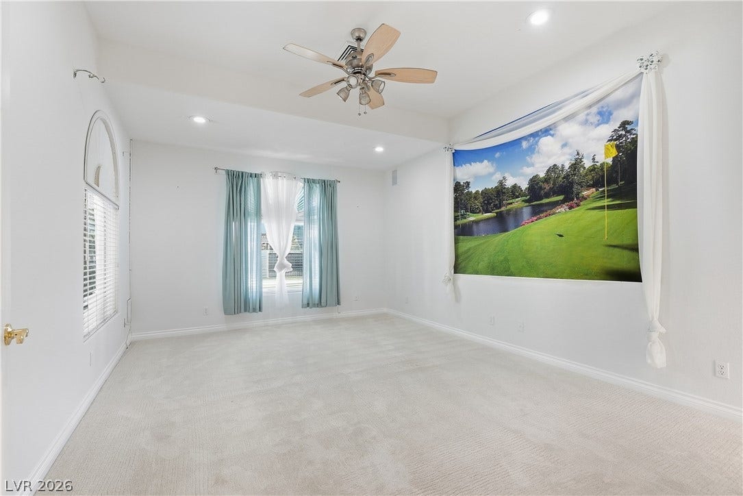 Plush carpeting and tray ceilings elevate this versatile secondary bedroom.