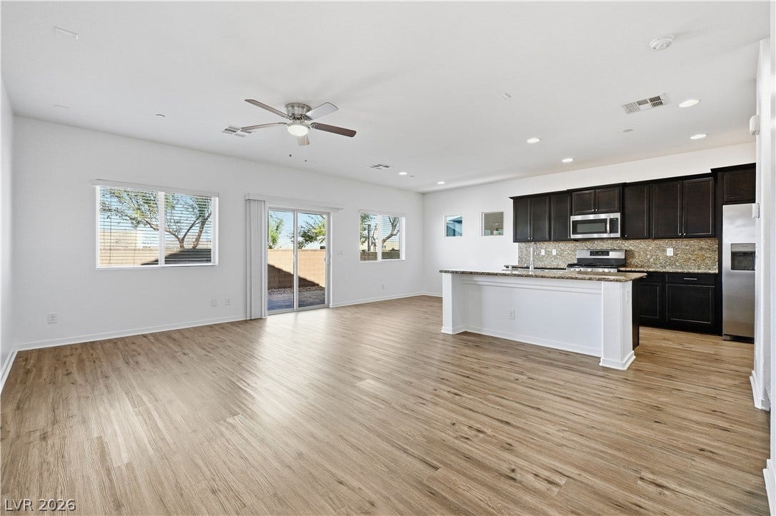 1122 Bradley Bay Avenue, Henderson, NV 89014 An open floorplan seamlessly connects the airy living area to a modern kitchen.