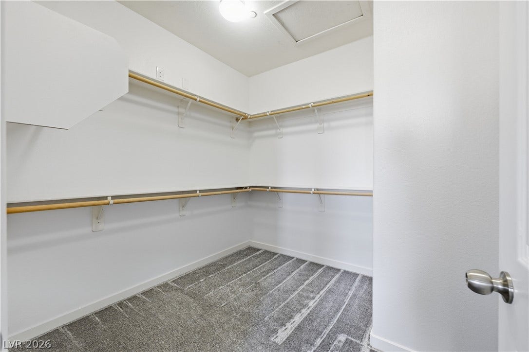 1122 Bradley Bay Avenue, Henderson, NV 89014 Ample hanging rods and soft carpeting maximize storage efficiency in this closet space.