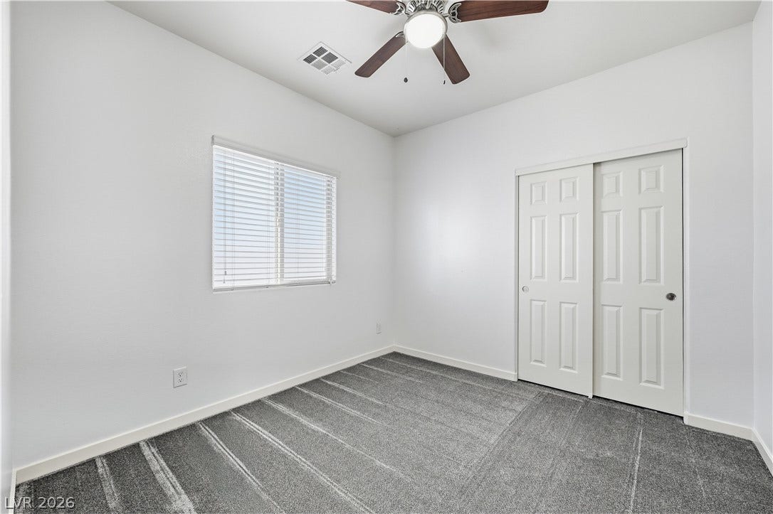 1122 Bradley Bay Avenue, Henderson, NV 89014 A window fills the space with natural light highlighting the clean lines and carpeted floor.