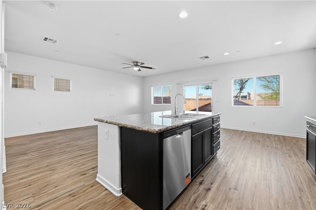 1122 Bradley Bay Avenue, Henderson, NV 89014 An open floorplan seamlessly connects the central kitchen island to the surrounding living spaces.