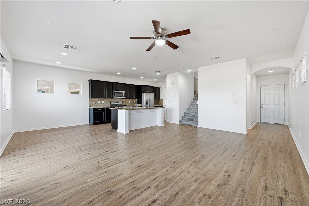 1122 Bradley Bay Avenue, Henderson, NV 89014 Gleaming wood-look floors anchor a sprawling, open layout connecting the main living spaces.