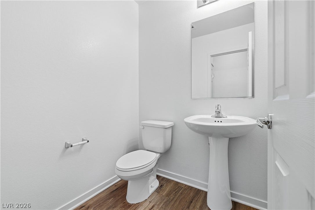 1122 Bradley Bay Avenue, Henderson, NV 89014 Clean lines and classic fixtures define this simple half bath layout.