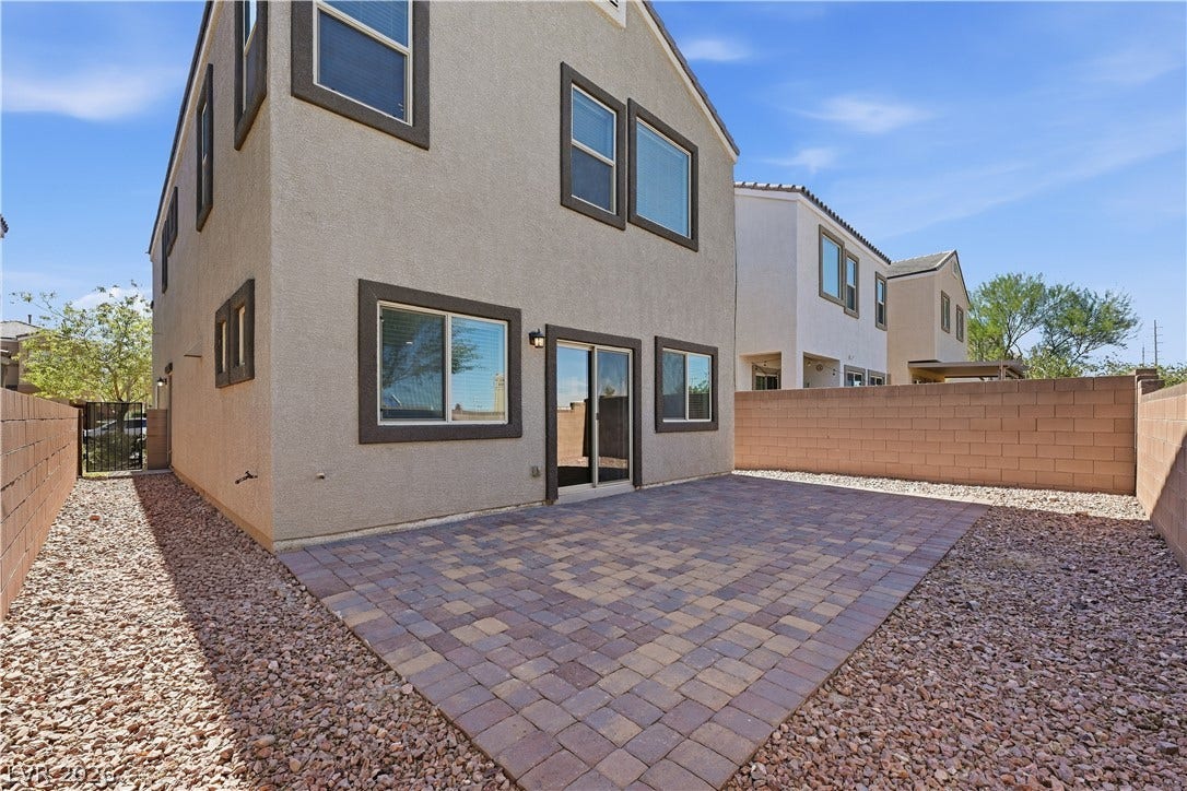 1122 Bradley Bay Avenue, Henderson, NV 89014 An inviting stone-paver patio anchors the enclosed low-maintenance backyard of this multi-level home.