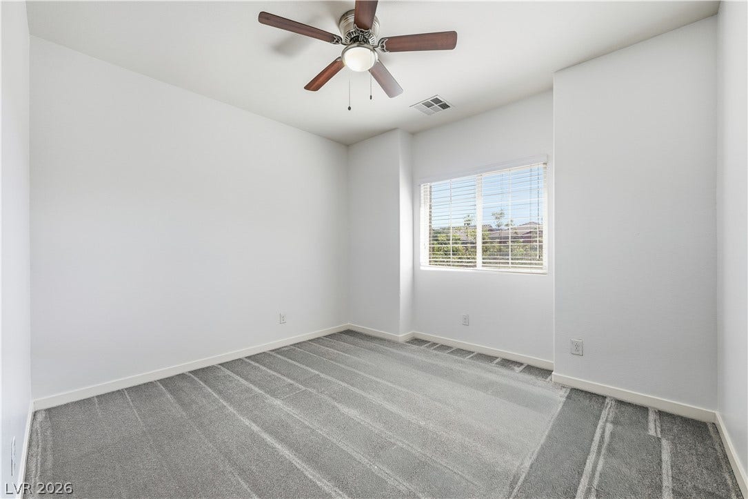 1122 Bradley Bay Avenue, Henderson, NV 89014 Plush carpeting and a wide window with integrated blinds create a serene personal retreat.