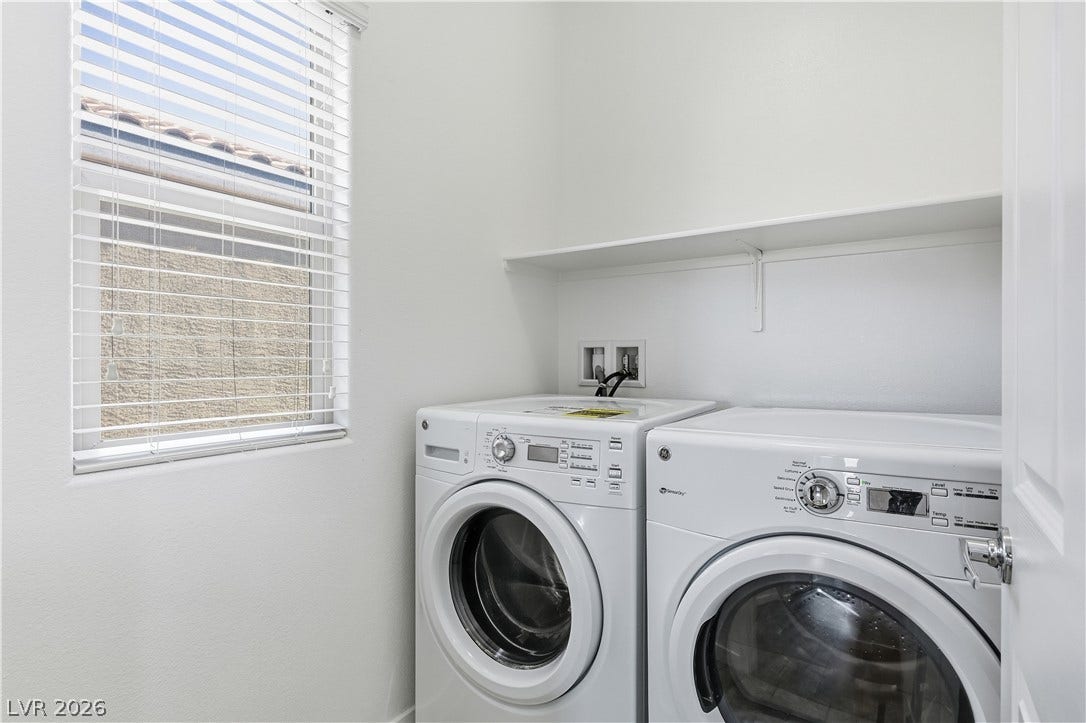 1122 Bradley Bay Avenue, Henderson, NV 89014 A functional laundry area features overhead shelving and a bright side window.