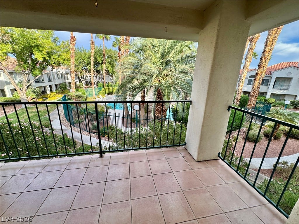 A private covered balcony overlooks the manicured courtyard and refreshing swimming pool.