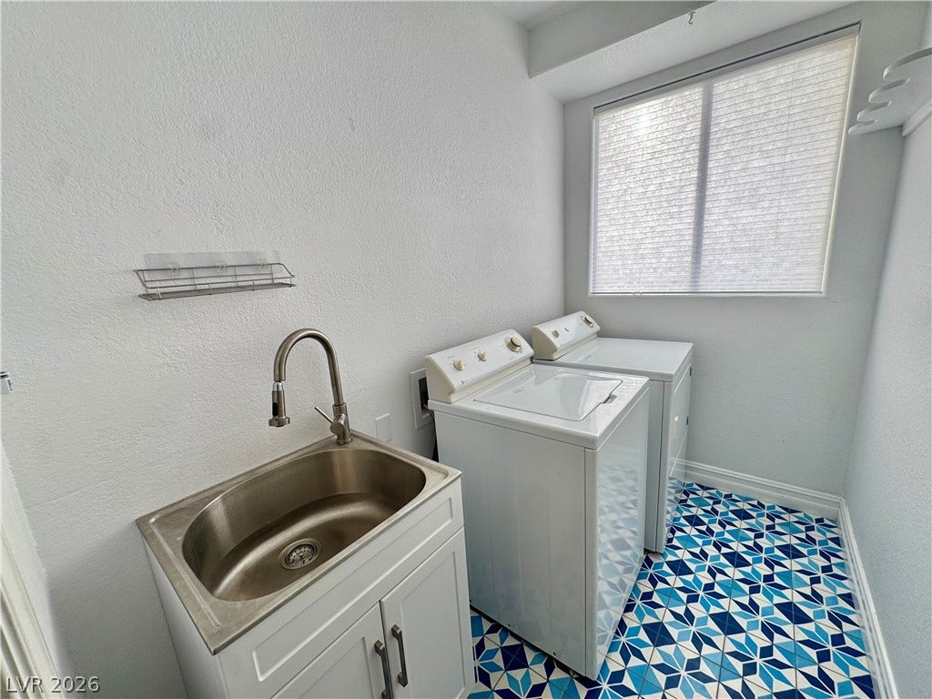 Patterned tile flooring brings a vibrant touch of character to this practical utility space.