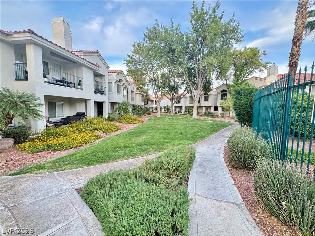 Paved walkways wind through beautifully landscaped greenbelts alongside Spanish tile rooflines.