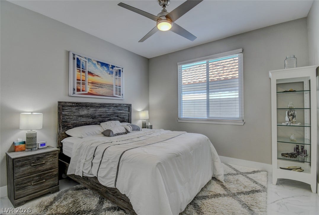 Polished tile flooring and clean lines define this serene, modern sleeping space.