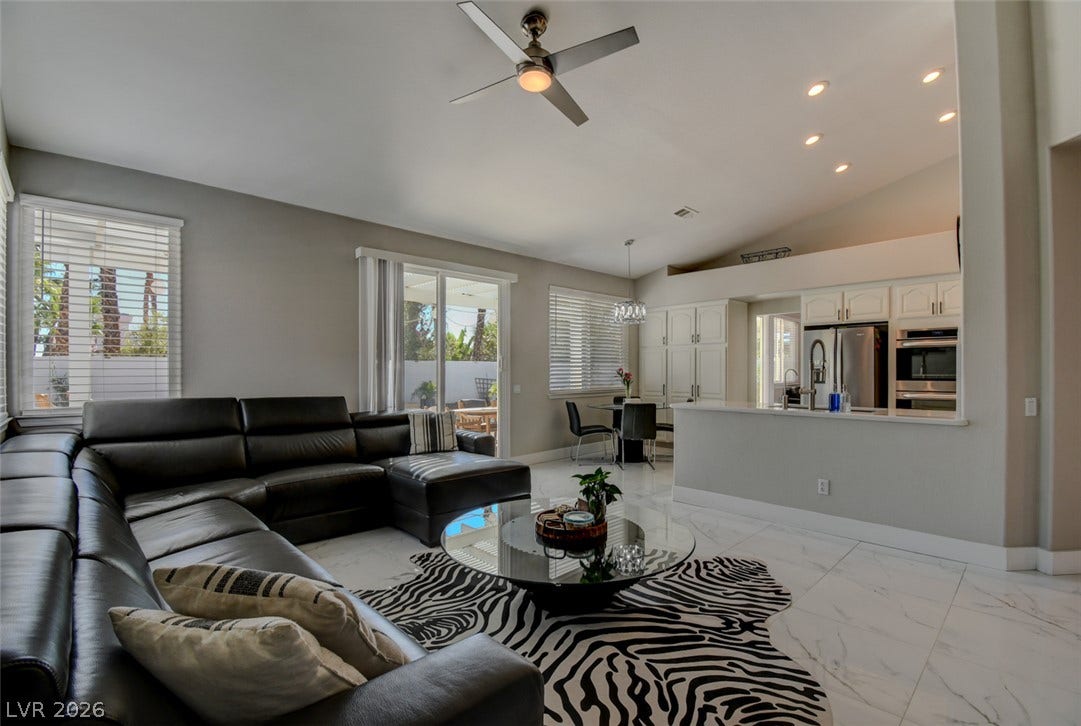 Polished tile flooring and high ceilings elevate this open living and dining area.