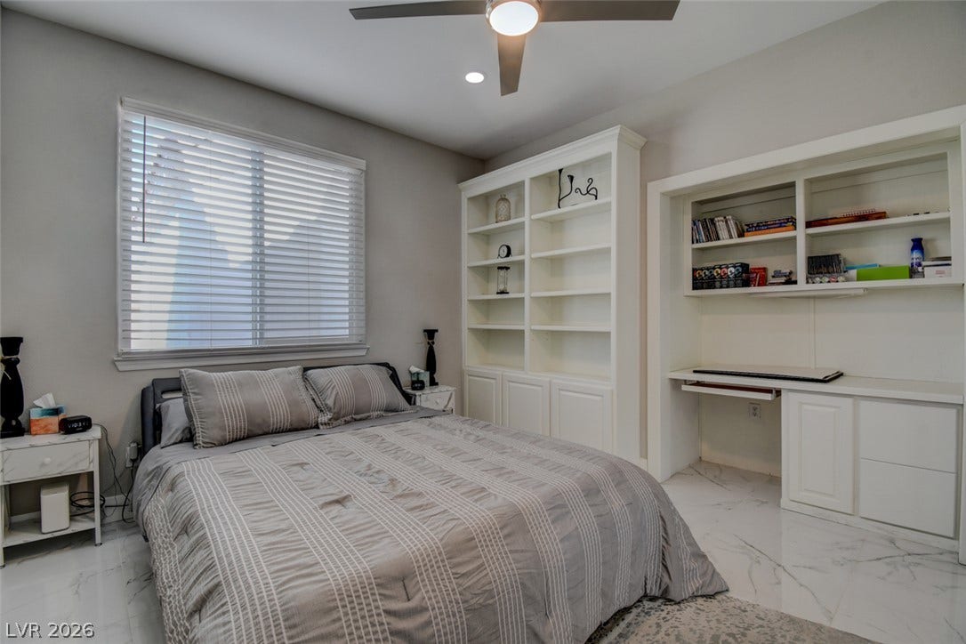 Built-in shelving and a custom desk area maximize functionality in this light-filled bedroom.
